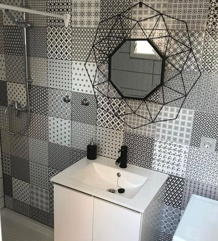 Newly fitted bathroom with grey patterned tiles